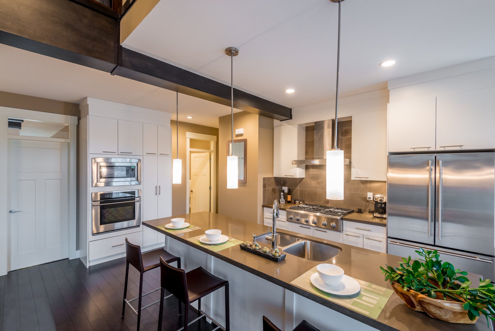 Modern, bright, clean, kitchen interior with stainless steel appliances in a luxury house